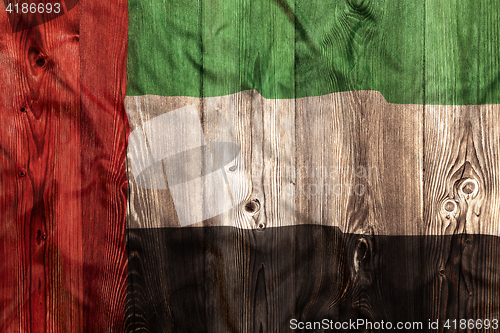 Image of National flag of United Arab Emirates, wooden background
