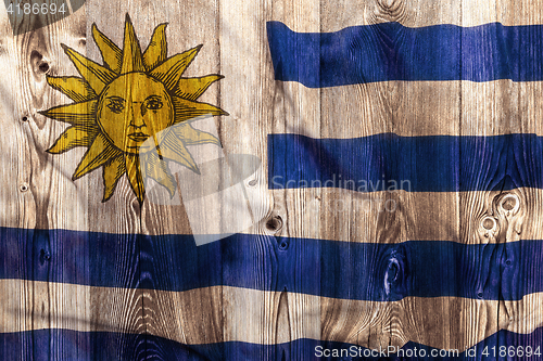 Image of National flag of Uruguay, wooden background