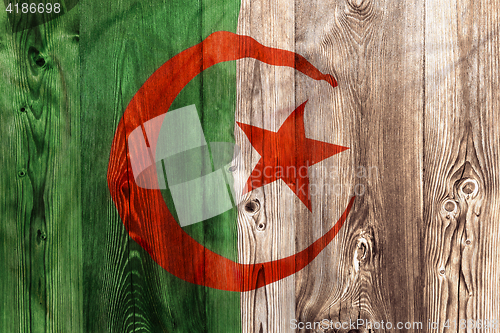 Image of National flag of Algeria, wooden background