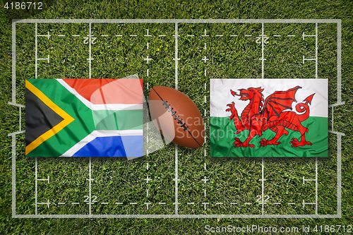 Image of South Africa vs. Wales flags on rugby field