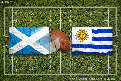 Image of Scotland vs. Uruguay flags on rugby field