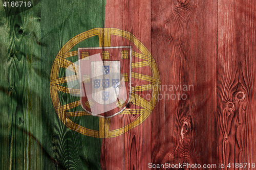 Image of National flag of Portugal, wooden background