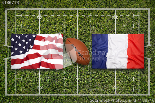 Image of USA vs. France flags on rugby field