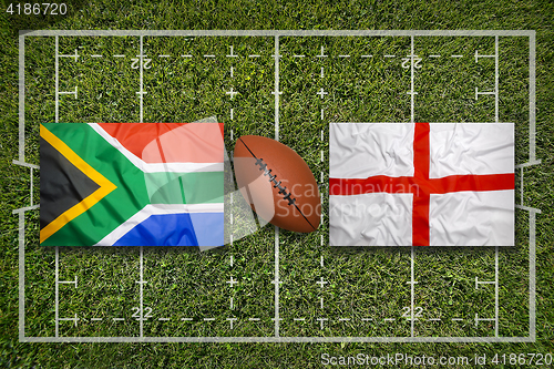 Image of South Africa vs. England flags on rugby field