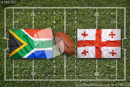 Image of South Africa vs. Georgia flags on rugby field