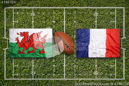 Image of Wales vs. France flags on rugby field