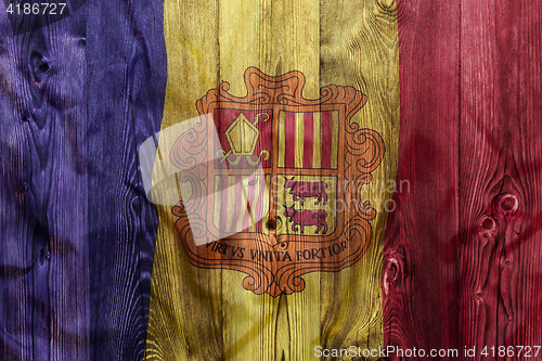 Image of National flag of Andorra, wooden background