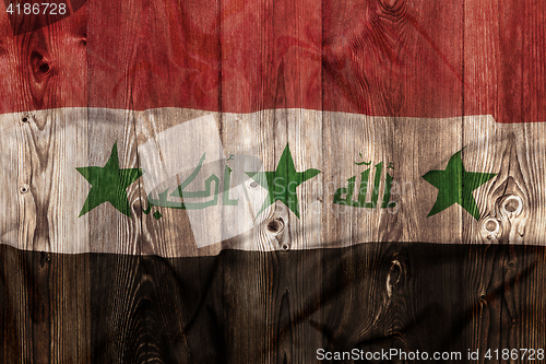 Image of National flag of Iraq, wooden background