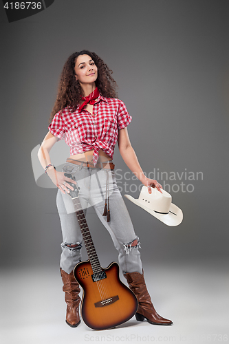 Image of The cowgirl fashion woman over a gray background