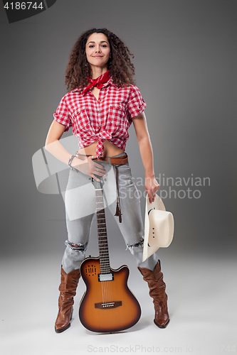 Image of The cowgirl fashion woman over a gray background