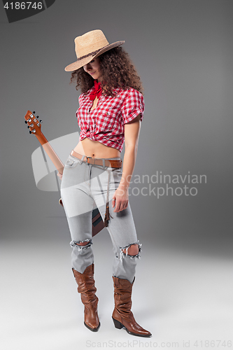 Image of The cowgirl fashion woman over a gray background