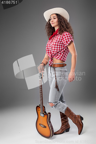 Image of The cowgirl fashion woman over a gray background