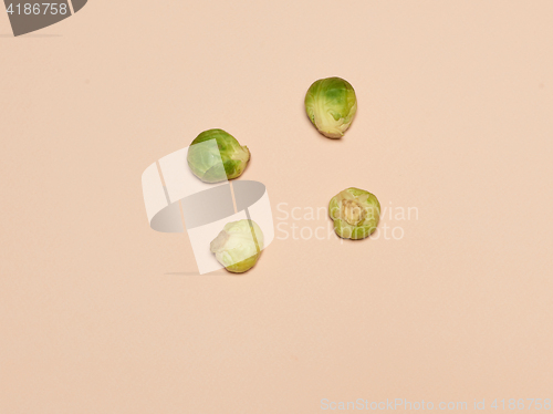 Image of The piles of Brussels sprouts on a pink background