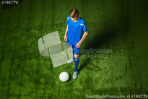 Image of Young boy with soccer ball doing flying kick