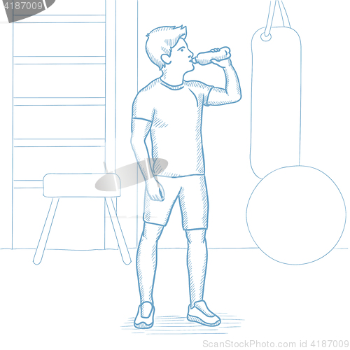 Image of Sportive man drinking water in the gym.