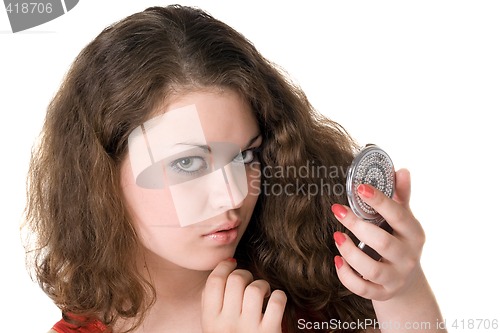Image of Portrait of the young woman with a mirror in hands. Isolated