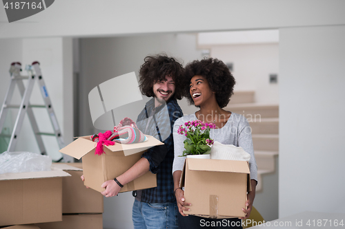 Image of multiethnic couple moving into a new home