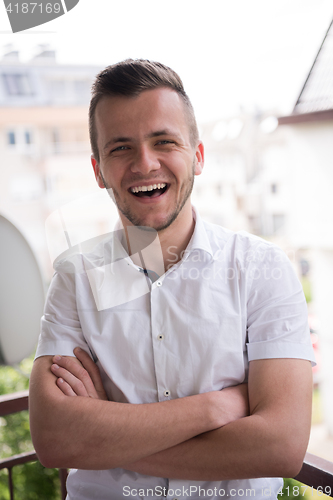 Image of man standing at balcony