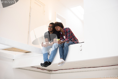 Image of couple having break during moving to new house