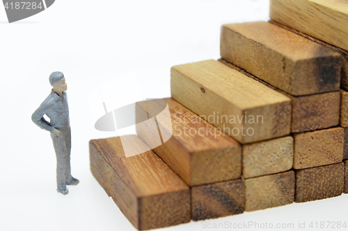 Image of Way to success with  businessman and wood block step