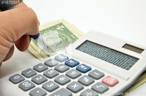 Image of Calculator, money and pen isolated on white