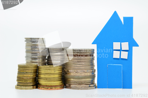 Image of House model and stacks of coins