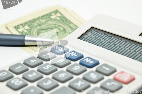 Image of Calculator, money and pen isolated on white