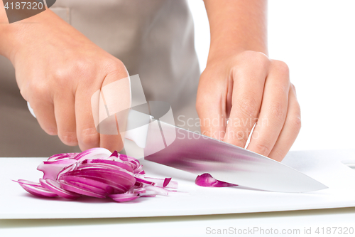 Image of Cook is chopping onion