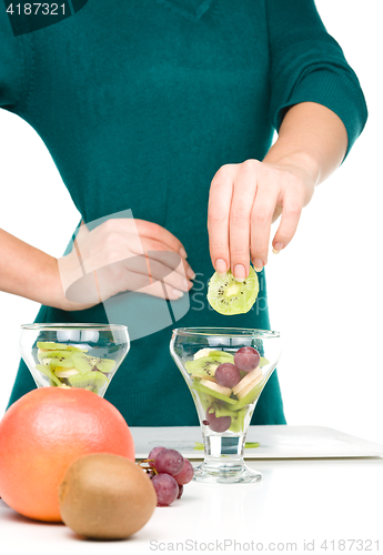 Image of Cook is preparing fruit dessert