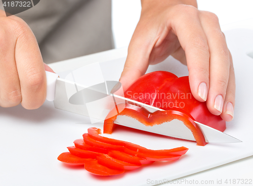 Image of Cook is chopping bell pepper