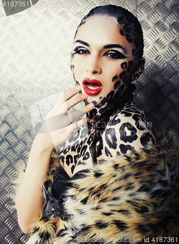 Image of young sexy woman with leopard make up all over body, cat bodyart