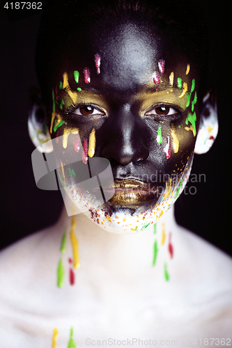 Image of woman with creative makeup closeup like drops of colors, facepai