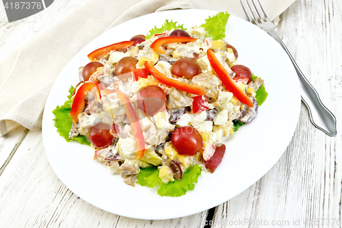 Image of Salad of meat and cheese with grapes on board