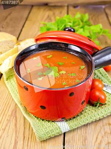 Image of Soup tomato in red bowl on board