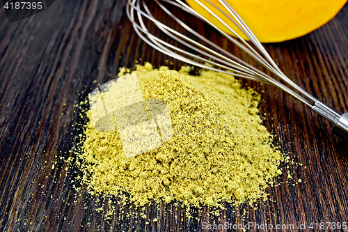 Image of Flour pumpkin with mixer and vegetable on dark board