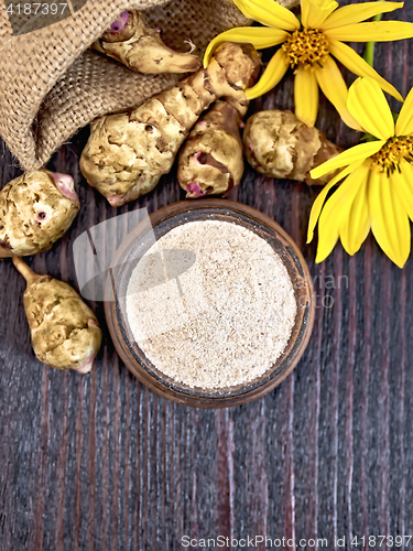 Image of Flour of Jerusalem artichoke in clay bowl on board top