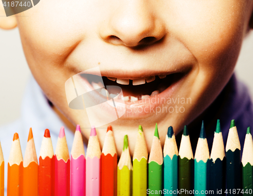 Image of little cute boy with color pencils close up smiling, education f