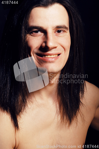 Image of handsome young man with long hair naked torso on black backgroun