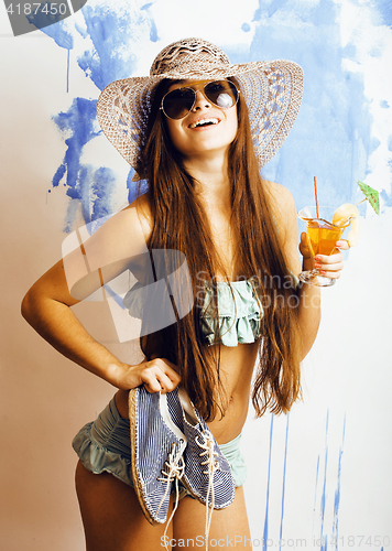 Image of cute bright woman in sunglasses and hat with cocktail in bikini 