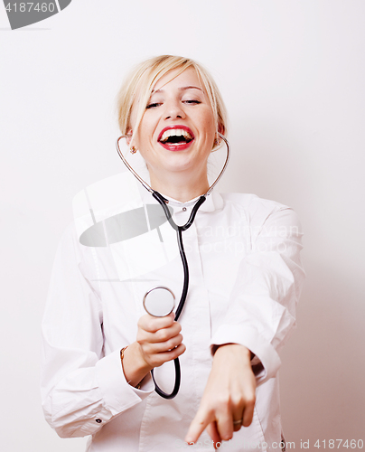 Image of young pretty woman doctor with stethoscope emotional posing, pointing in camers, lifestyle people concept