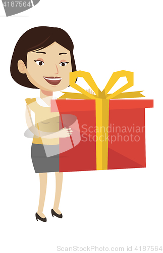 Image of Joyful caucasian woman holding box with gift.