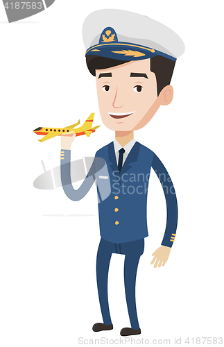 Image of Cheerful airline pilot with model airplane.