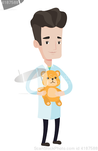 Image of Pediatrician doctor holding teddy bear.