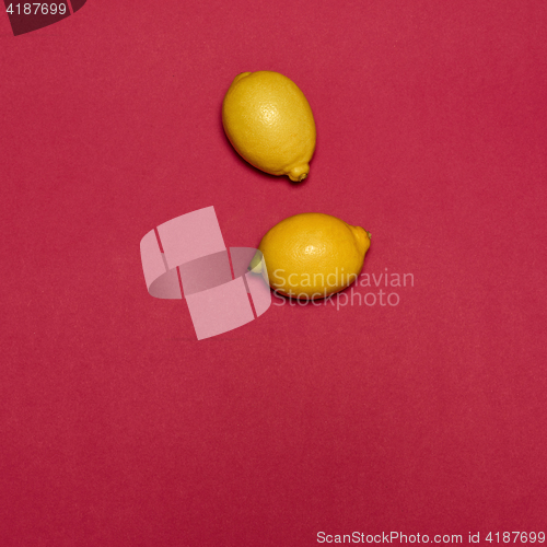 Image of Lemons on red background