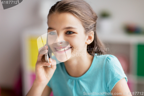 Image of close up of girl calling on smartphone at home