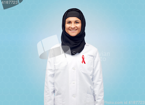 Image of muslim doctor in hijab with red awareness ribbon