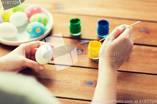 Image of close up of woman coloring easter eggs