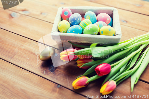 Image of close up of colored easter eggs and flowers