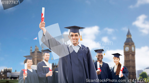 Image of happy students in mortarboards with diplomas