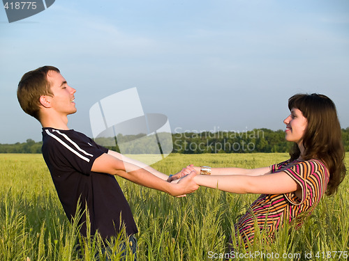 Image of Teen Couple Holding Hands Field